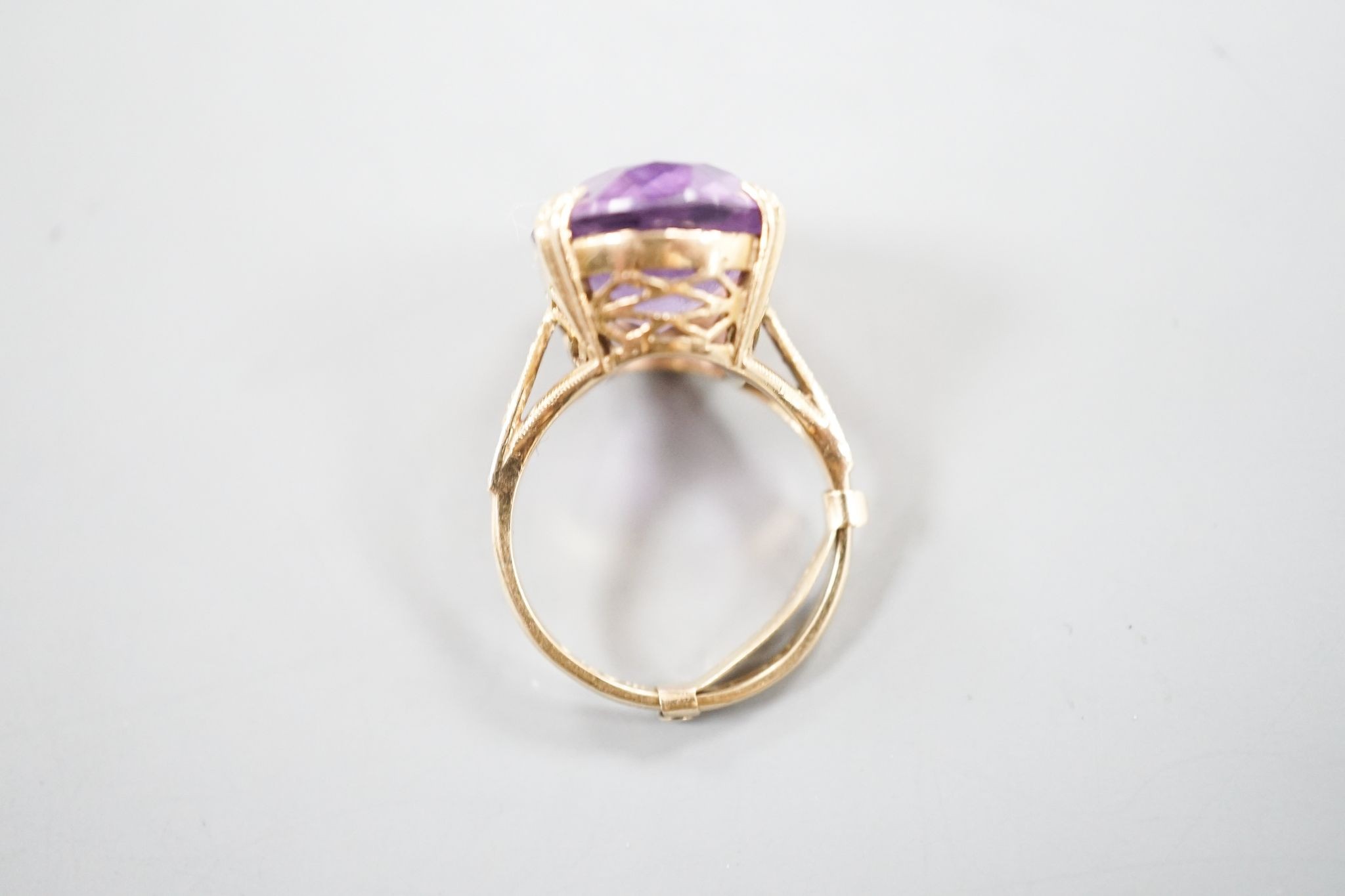 A modern 9ct gold and oval cut amethyst set dress ring, size L/M, gross weight 5.7 grams.